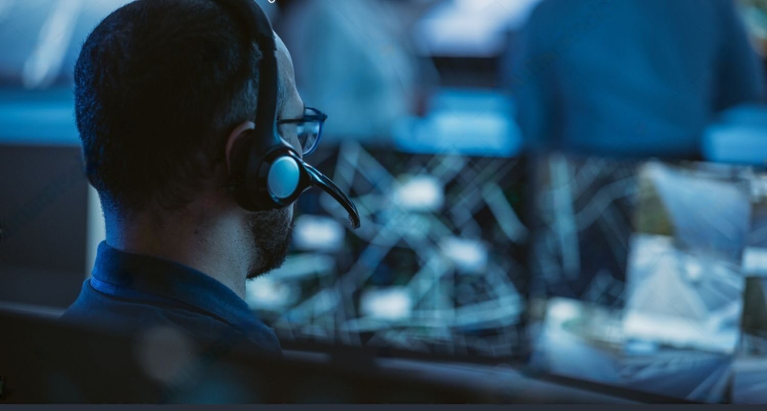 stock-photo-technical-customer-support-specialist-is-talking-on-a-headset-while-working-on-a-computer-in-a-call